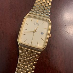 Citizen quartz watch with stainless steel gold band.